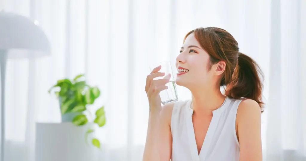 Woman Drinking Water Smiling